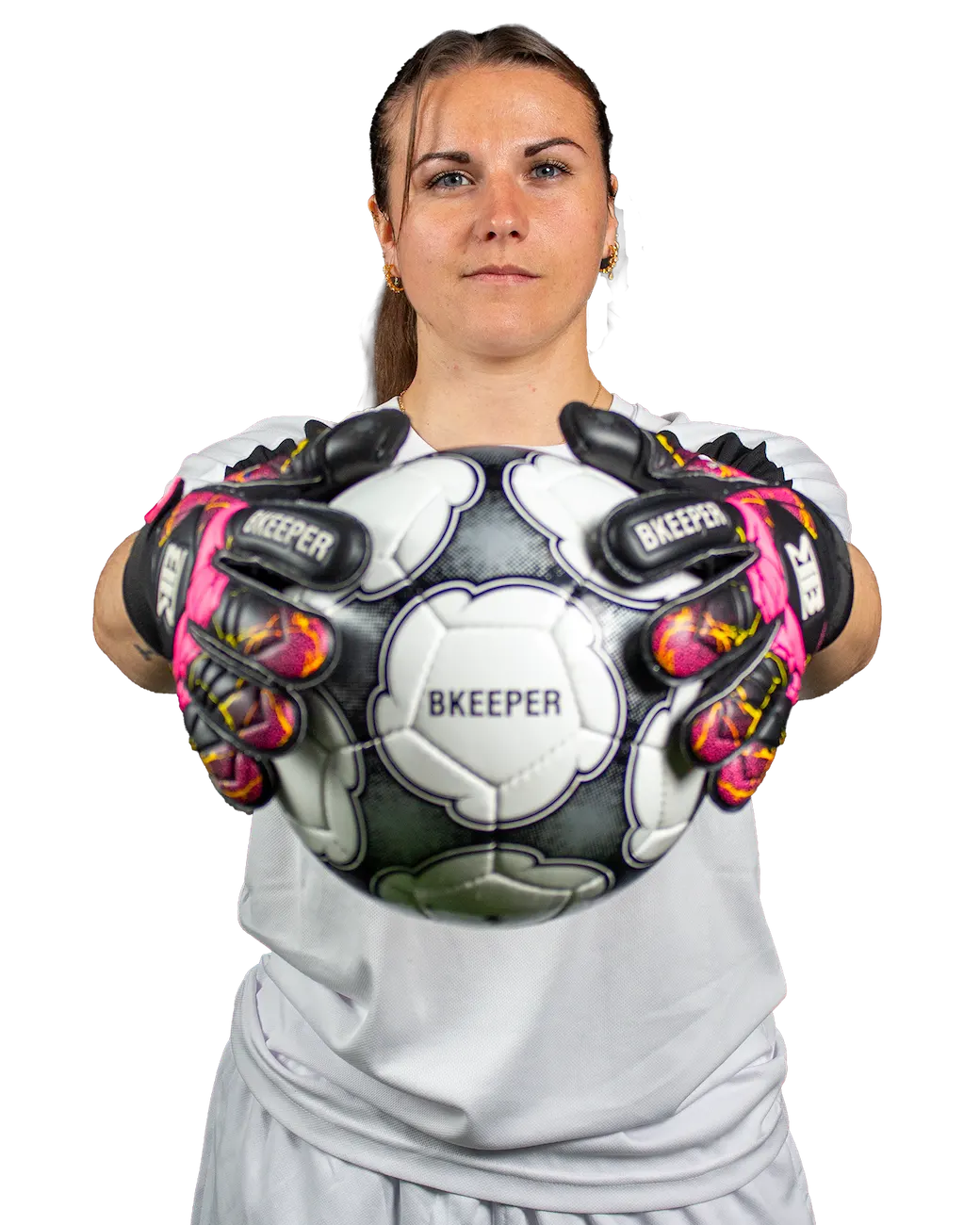 A female soccer goalkeeper wearing black, white, and pink Bkeeper gloves holds a black and white soccer ball against a solid white background.