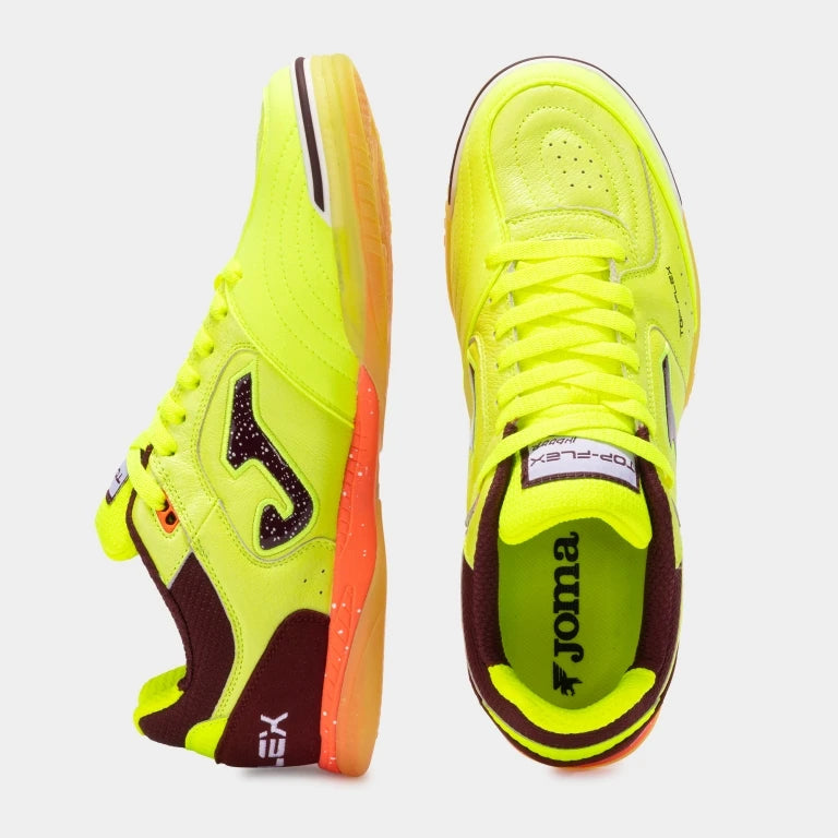 Pair of neon green sports shoes with brown accents on a light gray background