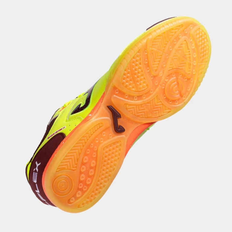 A close-up of a indoor court shoe showing its textured orange and yellow outsole against a light gray background.
