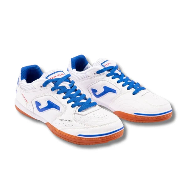 A pair of Joma indoor court shoes in white, featuring vibrant blue laces, blue logo accents, and orange outsoles, shown against a plain white background.