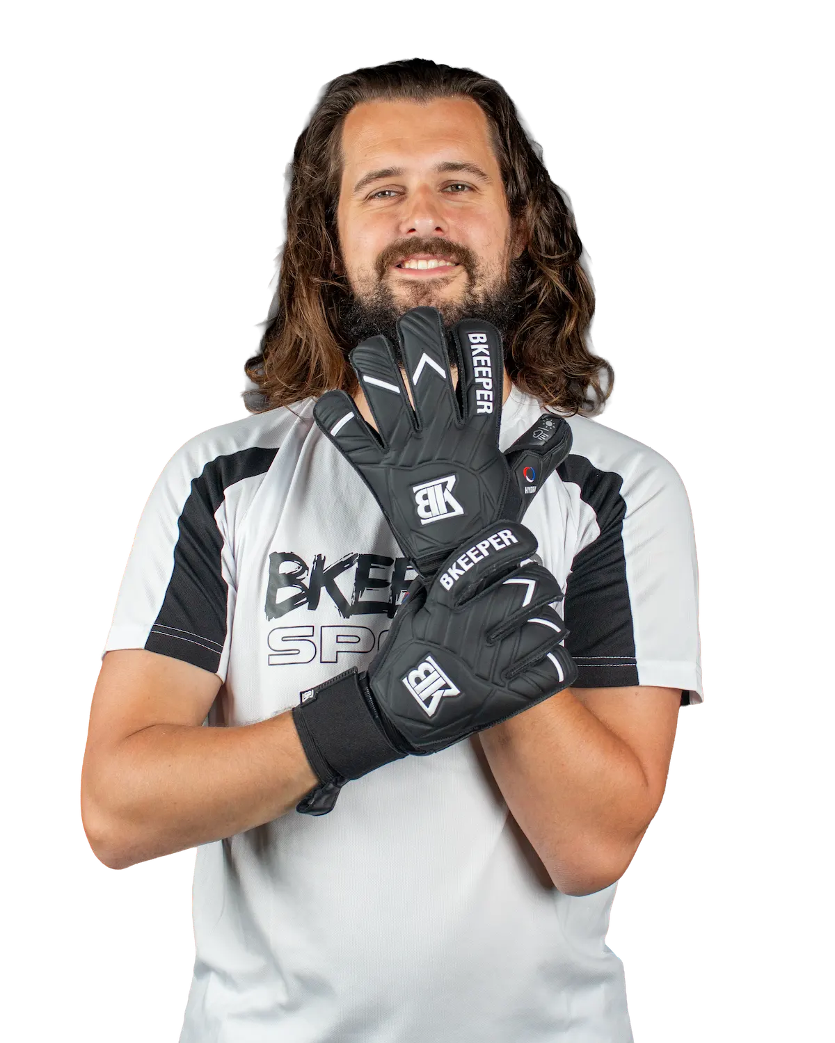 A man with long brown hair and a beard wearing a white and black athletic jersey holds up a pair of black and white BKEEFER Bicepher gloves in front of his face, against a solid white background.