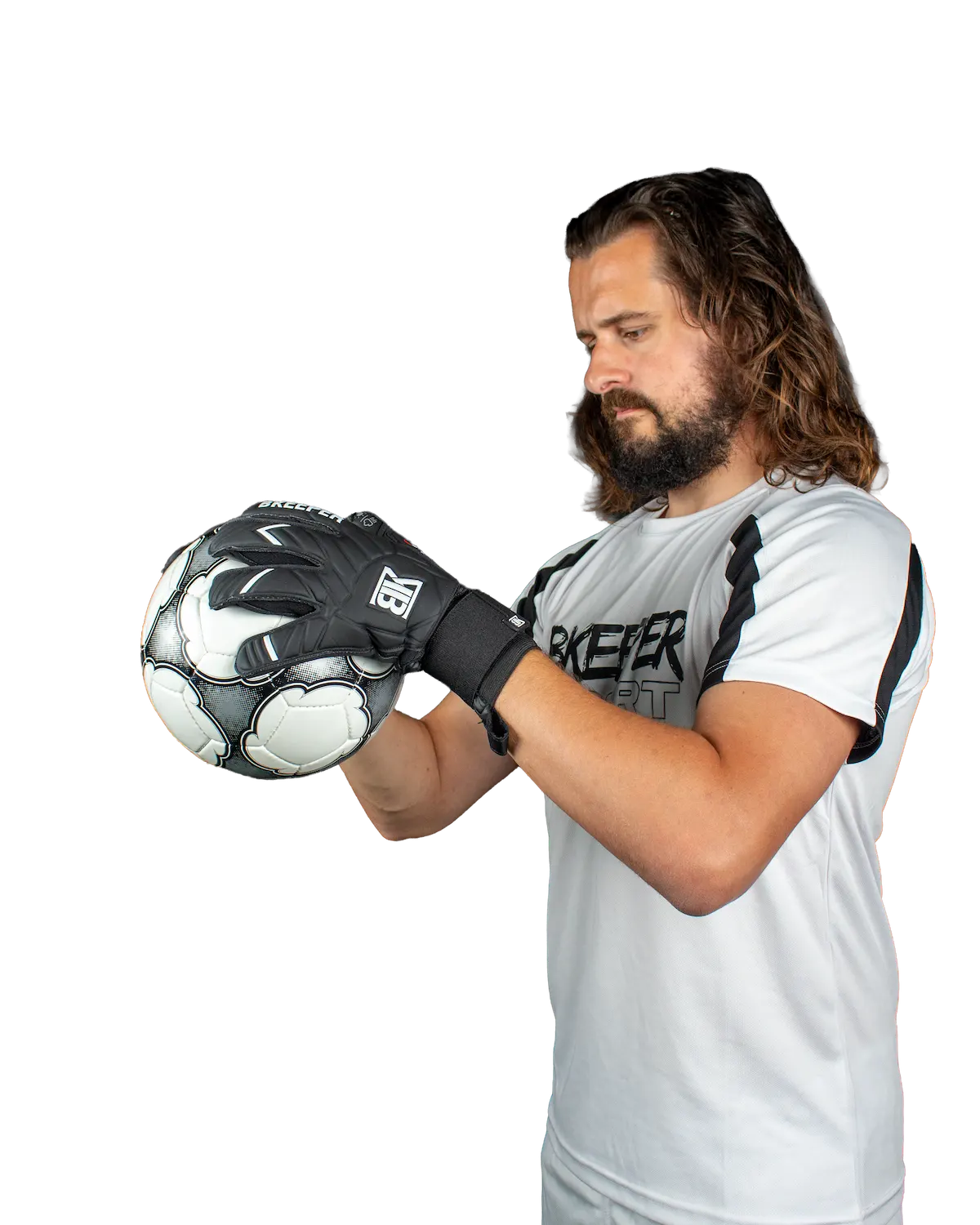 A man with long brown hair and a beard wearing a white t-shirt and black goalkeeper gloves, holding a black and white soccer ball against a solid white background.