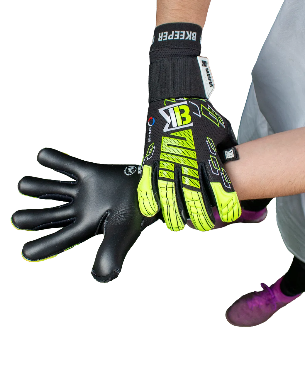 A pair of goalkeeper gloves shown on a person's hands against a plain white background. One glove is worn on the back of the hand, showing a black and neon yellow-green design with white and black branding, and the other is shown flat on the palm in black with neon yellow-green accents.