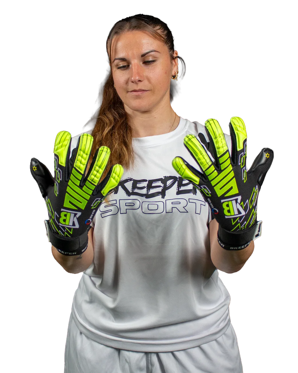 A woman wearing a white sports jersey and shorts holds up a pair of black and neon yellow-green goalkeeper gloves with 'BK' branding, against a plain white background.